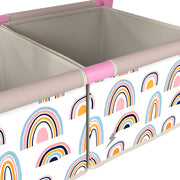Close-up of the two rainbow-print fabric storage bins on the pink easel