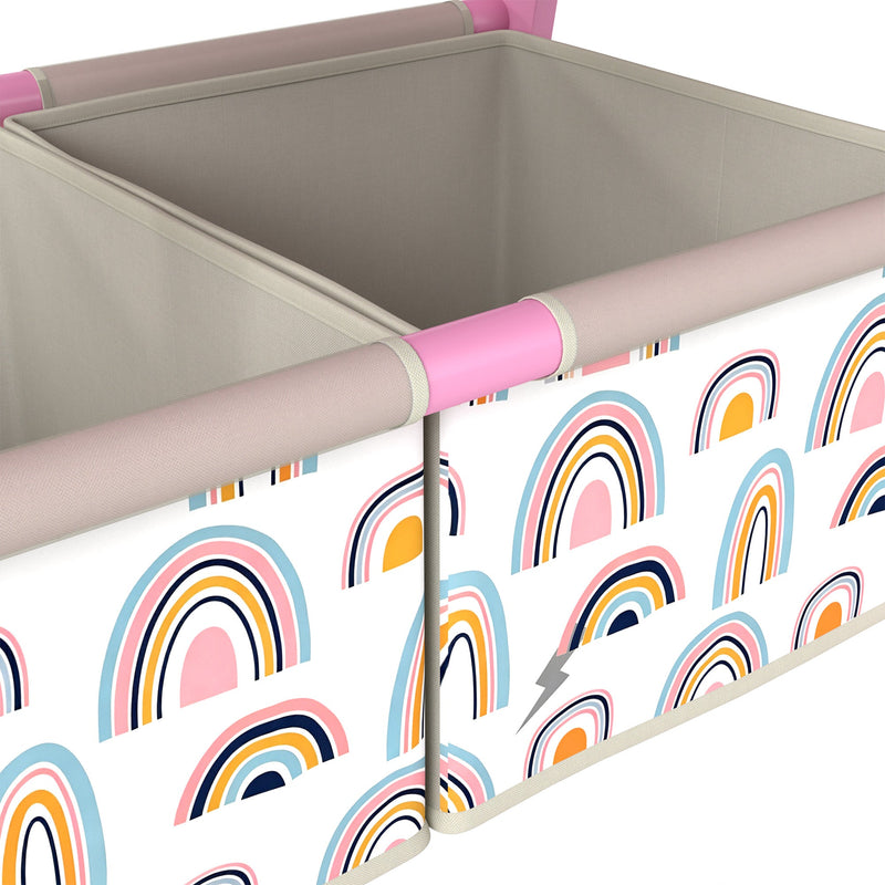Close-up of the two rainbow-print fabric storage bins on the pink easel