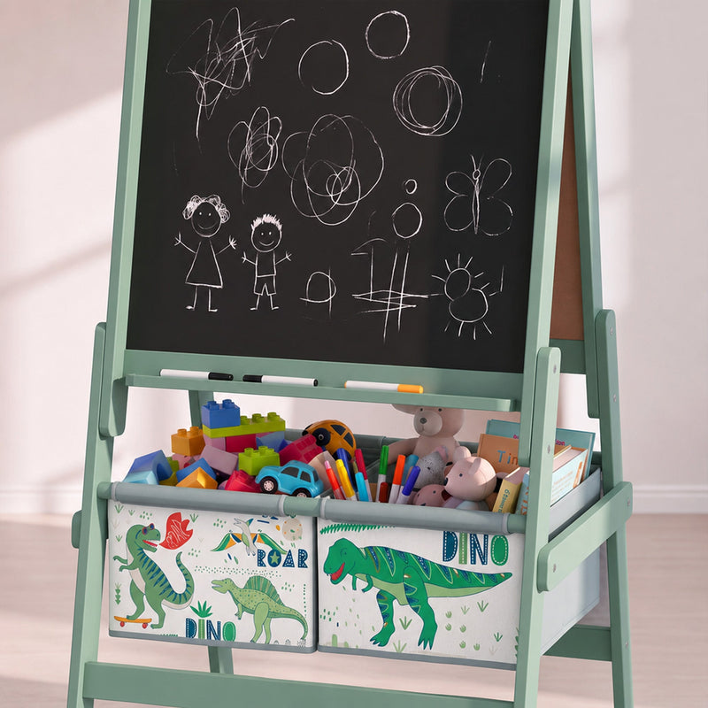 Close-up of chalk drawings on the green easel chalkboard above bins full of toys
