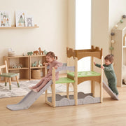 Two children playing on the indoor playset, one sliding and one at the tower
