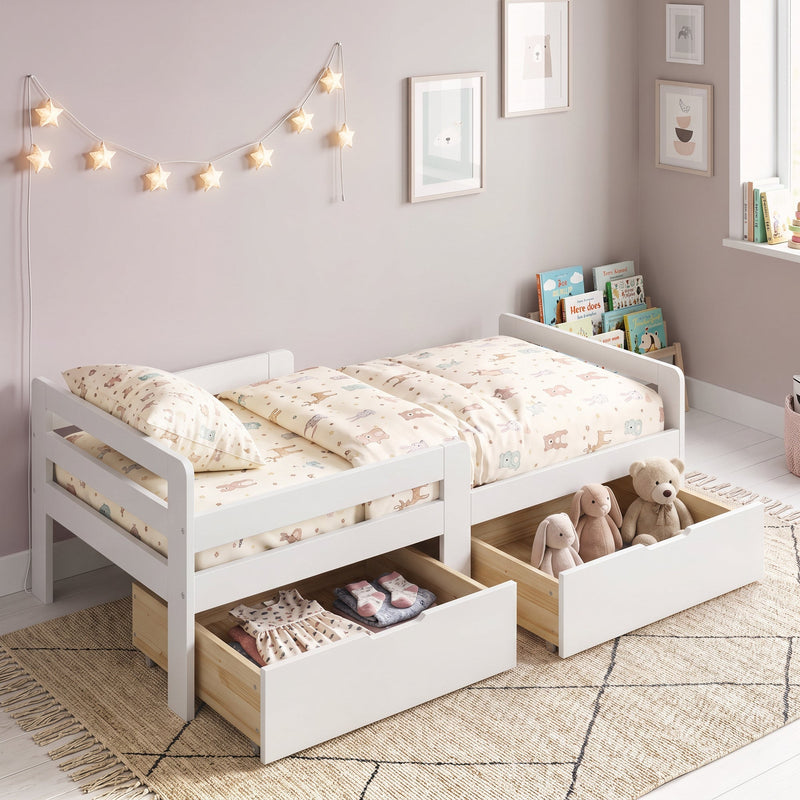 White kids bed with both drawers pulled out showing clothes and soft toys