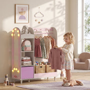 Young girl choosing a dress from the pink clothes rail in a sunlit bedroom