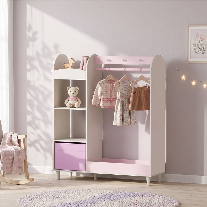 Pink clothes rail styled in a bedroom with a teddy bear on the shelf and clothes hanging