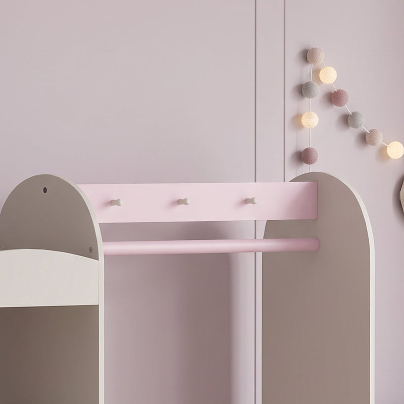 Close-up of the three bow shaped hooks above the pink hanging rod