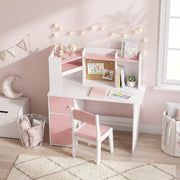 Pink kids desk set in a bedroom with fairy lights and a cork board