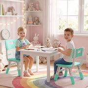 Two boys drawing at a small table, each seated on a kids desk chair