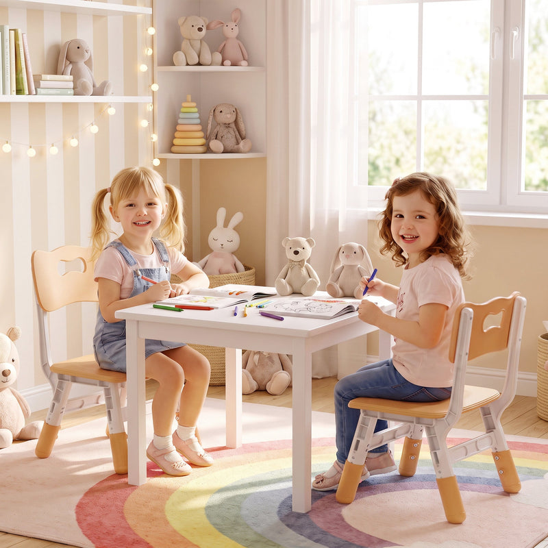 Two girls drawing at a small table, each seated on a kids desk chair