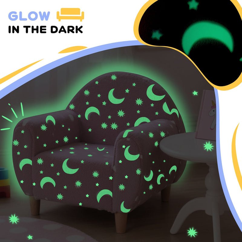 Glow-in-the-dark star and moon pattern lit up on the kids armchair in a dark room