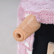 Close-up of a wooden-look leg on the pink kids armchair