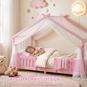 Dual guardrails highlighted on the pink house bed frame with a sleeping child