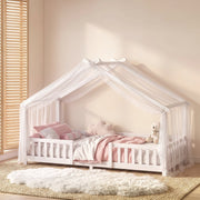 Styled bedroom scene with the white house bed frame dressed in pink and cream bedding