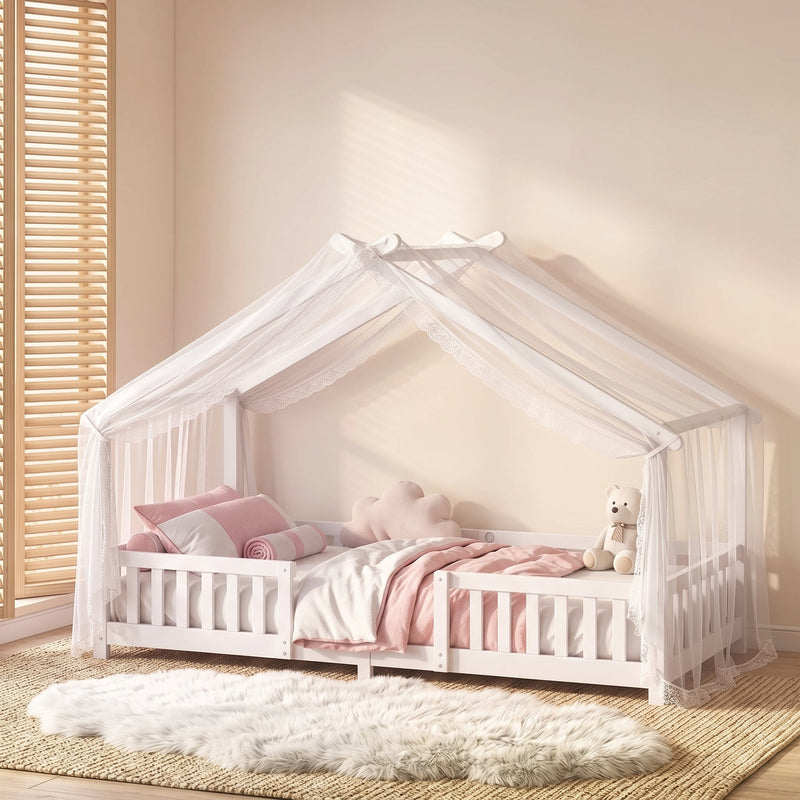 Styled bedroom scene with the white house bed frame dressed in pink and cream bedding