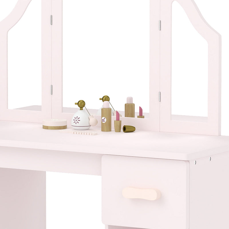 Close-up of the tabletop with toy beauty accessories, the mirror and a drawer