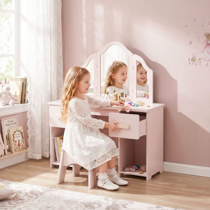 Girl sitting at the pink dressing table with a drawer open in a pink bedroom