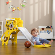 Toddler sitting at the bottom of the yellow Aiyaplay slide with a basketball