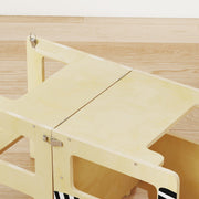 Close-up of the fold-out desk surface and locking clip mechanism