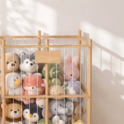 Close-up of stuffed animals held behind the elastic cords