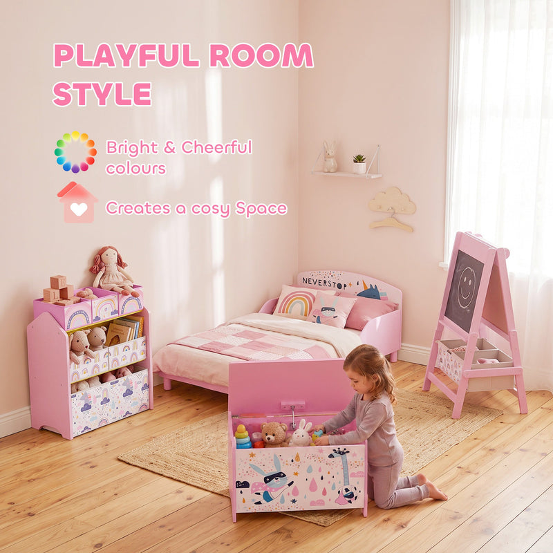 Pink toy chest in a kids room beside a matching bed and easel