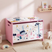 Closed pink toy chest with a giraffe and bunny print beside a shelf and soft toys