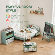 Green dinosaur toy chest in a kids room beside a matching bed and easel