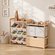 Toy storage unit in a bedroom corner filled with bins of toys and grey fabric drawers