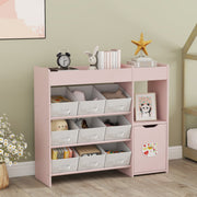 Toy storage unit filled with toys and books beside a house-frame bed