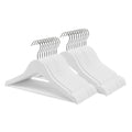 Stack of white wooden kids clothes hangers with trouser bars