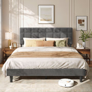 Slate grey upholstered king size bed made up with white bedding between two wooden bedside tables