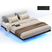 Studio shot of the Vasagle King Floating Bed Frame made up with bedding, showing a close-up of the built-in 2 AC outlet and USB charging panel