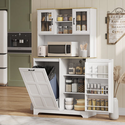 Kitchen cupboard in a green kitchen holding a microwave, toaster and pantry jars