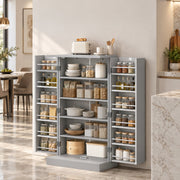Grey pantry cabinet with both doors open and shelves and door racks full of jars and plates in a kitchen