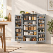 Grey pantry cabinet with doors open in a bright kitchen next to a wooden table