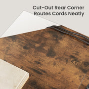 Close-up of the cut-out rear corner of the desktop with cables routed neatly through the gap