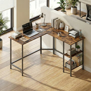 Overhead view of the L-shaped desk in a bright room by tall windows with a laptop, lamp, books and files