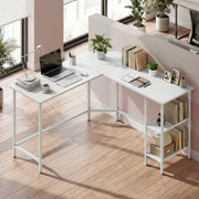 Desk in a bright room with a laptop, books and storage boxes on the lower shelves