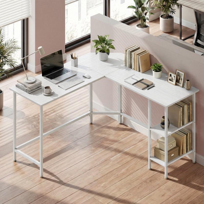 Desk in a bright room with a laptop, books and storage boxes on the lower shelves
