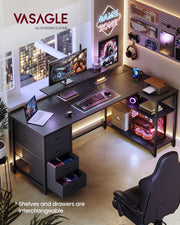Ebony black L-shaped desk in a room setup with a monitor on the stand and two drawers pulled open