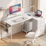 L-shaped desk in a home office with monitor, laptop and desk chair