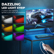 Six LED colour options on the gaming desk strip light with a controller in hand
