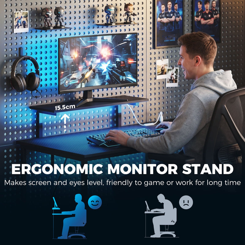 Man gaming at the desk with a 15.5 cm monitor stand raising the screen to eye level