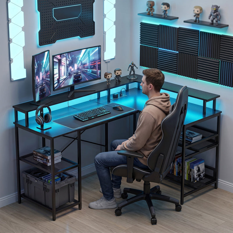 Man working at the L shaped desk on a wooden floor with games stored on the mesh shelves