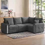 Dark grey L shaped sofa in a bright living room on a patterned rug