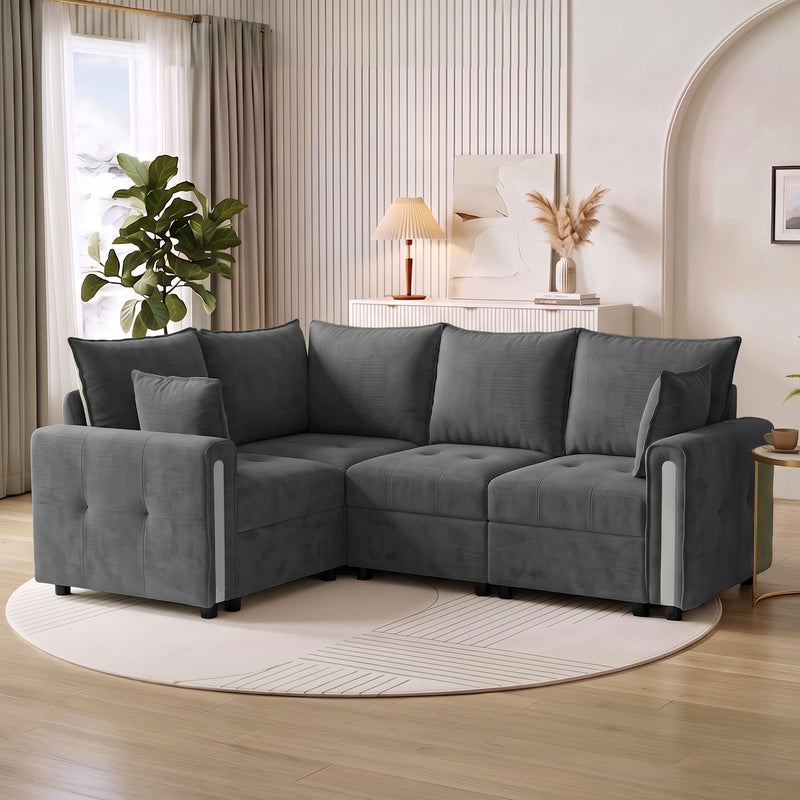 Dark grey L shaped sofa on a round rug in a living room with a plant