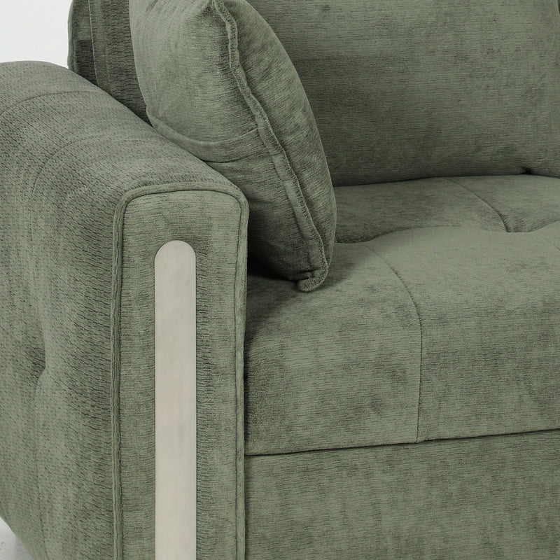 Close-up of the dark green velvet arm with a pale trim panel and a scatter cushion