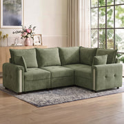 Dark green velvet L-shaped sofa in a bright living room on a patterned rug