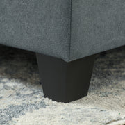 Close-up of the angled wood leg supporting one of the sofa modules