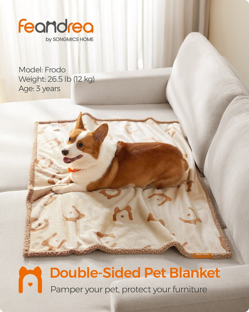 Lifestyle shot of the Feandrea double-sided pet blanket draped on a sofa with a dog