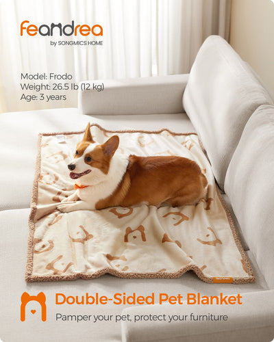 Lifestyle shot of the Feandrea double-sided pet blanket draped on a sofa with a dog