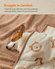 Close-up of a dog snuggled in the reversible sherpa and flannel sides of the blanket