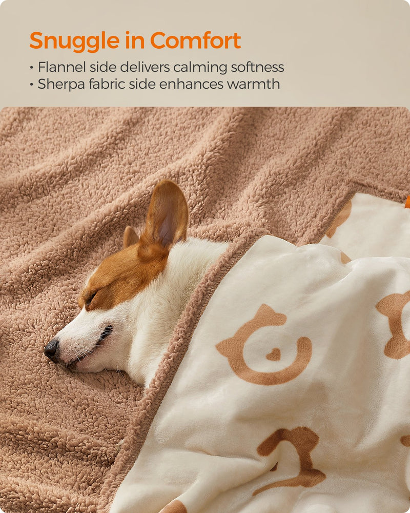 Close-up of a dog snuggled in the reversible sherpa and flannel sides of the blanket